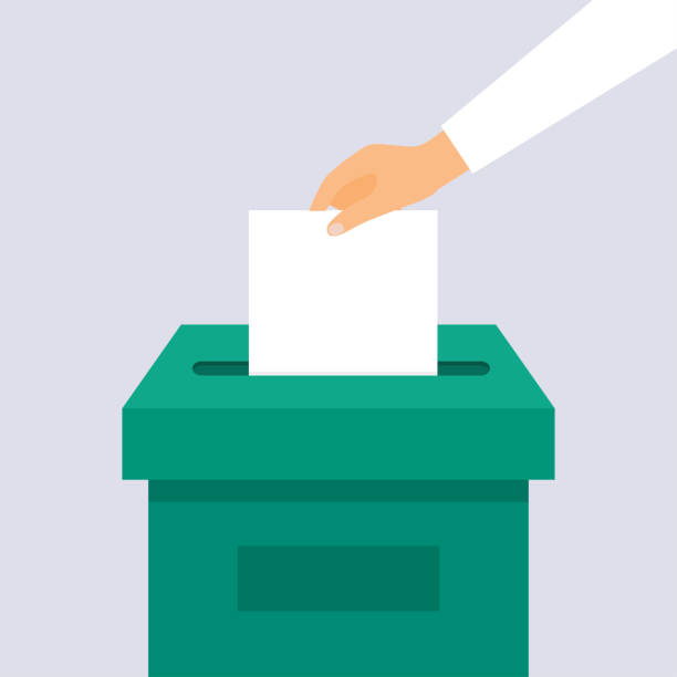 Hand placing paper in a ballot box