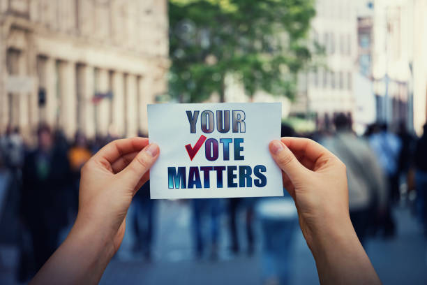 Two hands holding up a sign that says your vote matters