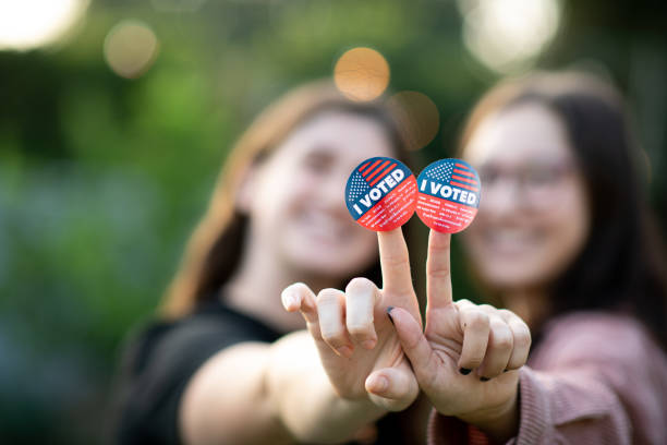 Two women holding up I Voted stickers on their fingers proudly